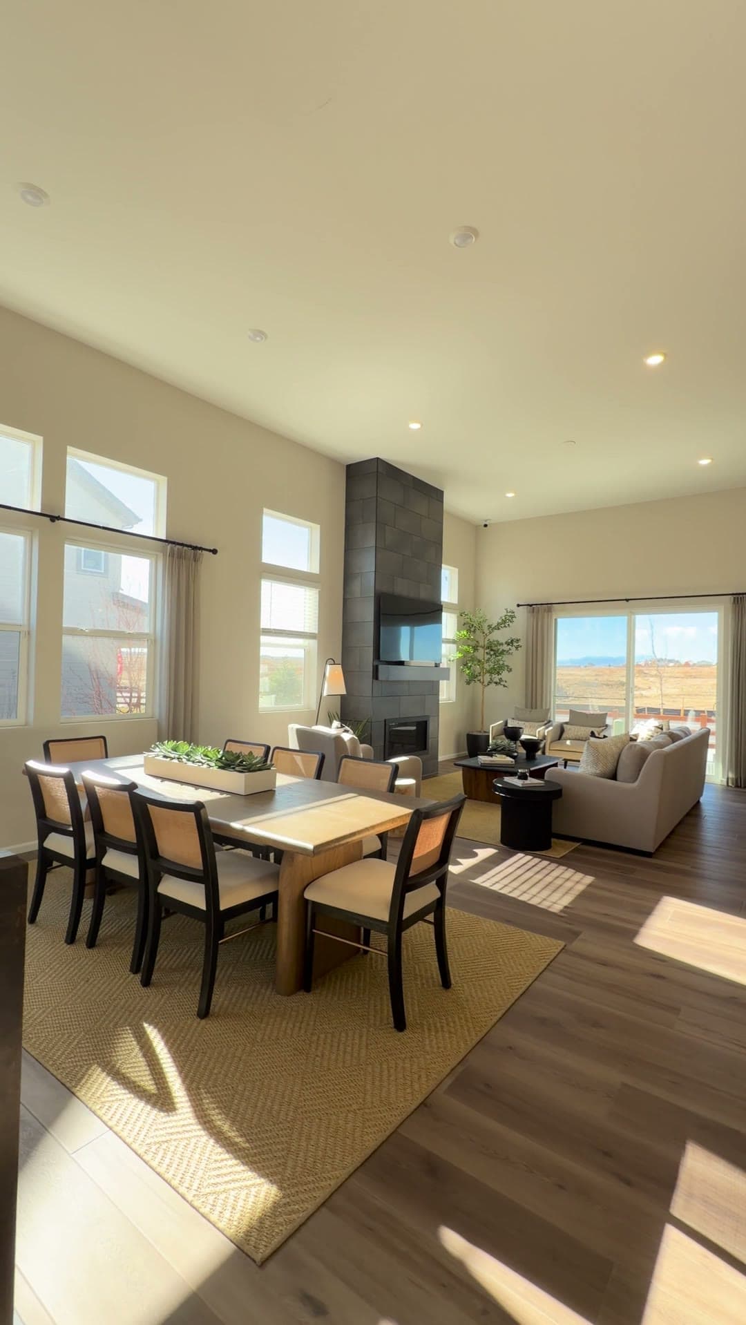 Great room of a Colorado home with a tile fireplace and mountain views